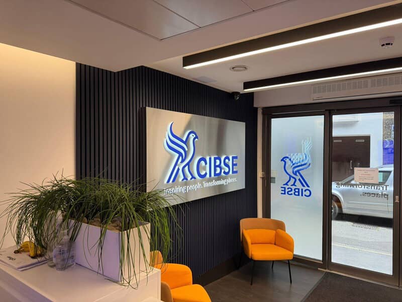 An image of the blue CIBSE logo and signage on the interior and doors.